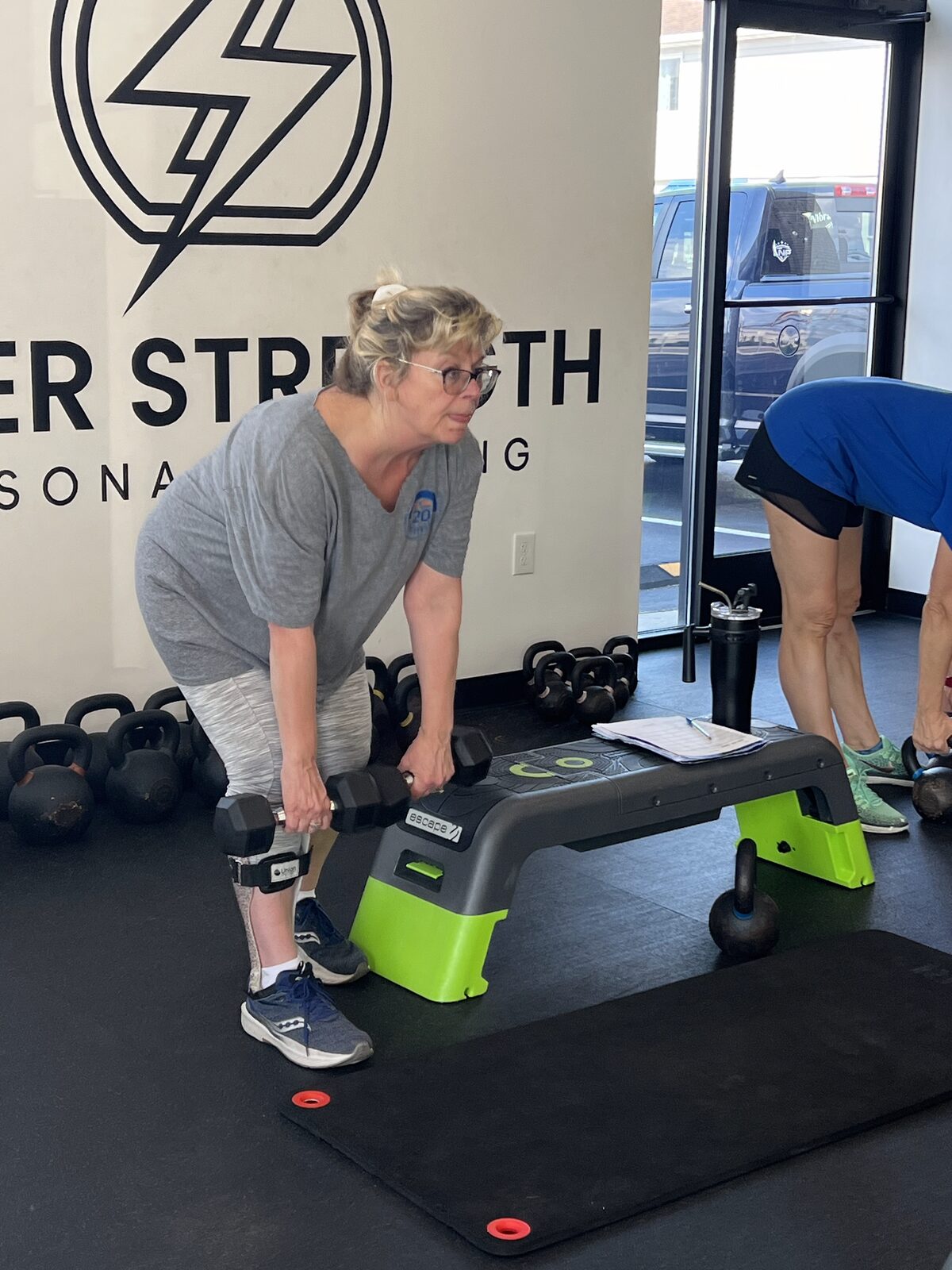 A member mid-set on a barbell deadlift