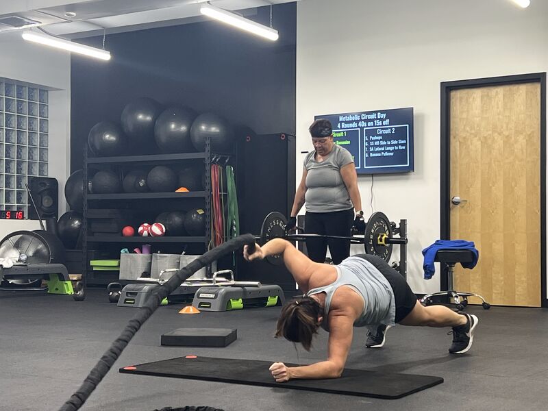 A member working battle ropes