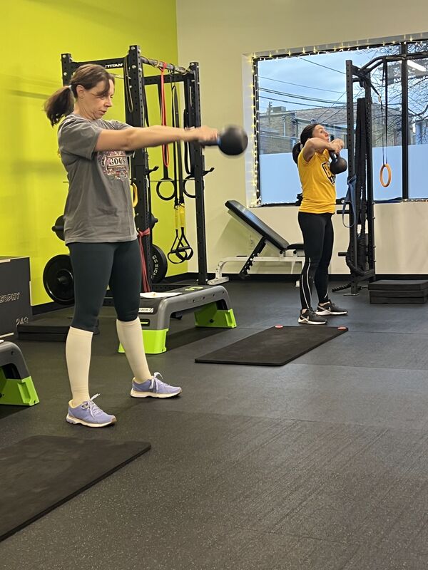 A member training with dumbbells